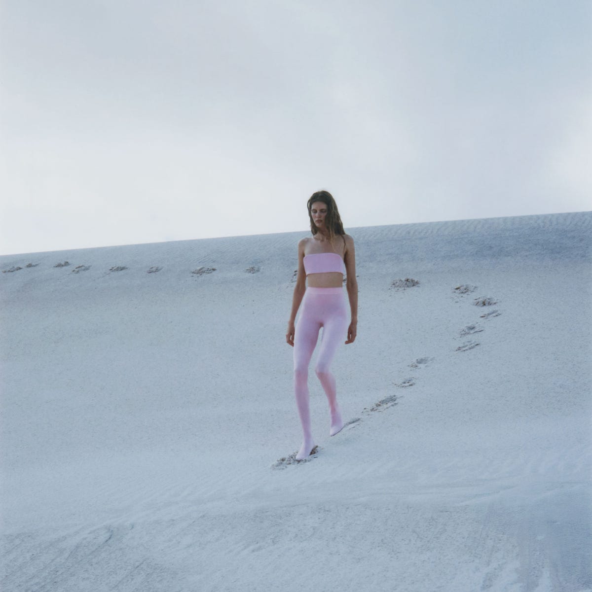 a person walking on a sandy surface a person walking on a sandy surface