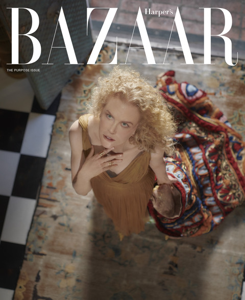 harper's bazaar cover with camera directly above nicole, nicole wears a gold dress and holds a multicolored blanket, she stands on a colorful rug over a black and white tiled floor