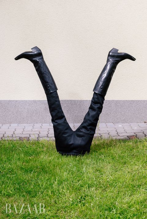 upside down pants and boots on a grass lawn