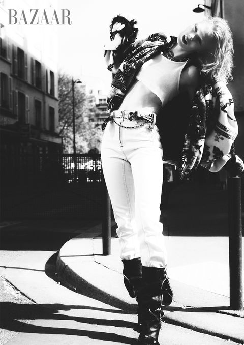 model poses in louis vuitton x fornasetti jacket free people top louis vuitton jeans and boots balenciaga necklace ysl belt chanelt belt versace foulard