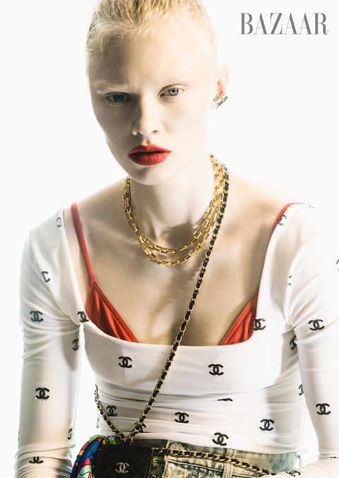 model poses in chanel top jeans card holder on chain belt and bandanna eres bikini top alexander mcqueen ear cuff saint laurent by anthony vaccarello belt worn as necklace