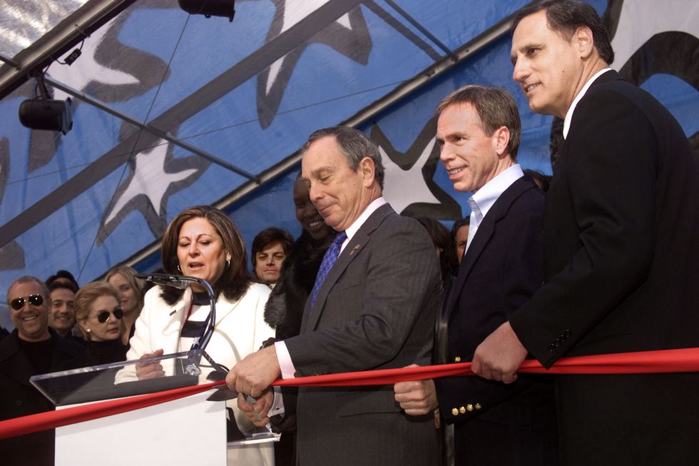 mayor michael bloomberg cutting the ribbon to kick off the mercedes benz fashion week at bryant park in new york city fern mallis, tommy hilfiger and david schembri, vp of marketing for mercedes benz usa look on 282002 photo evan agostiniimagedirec