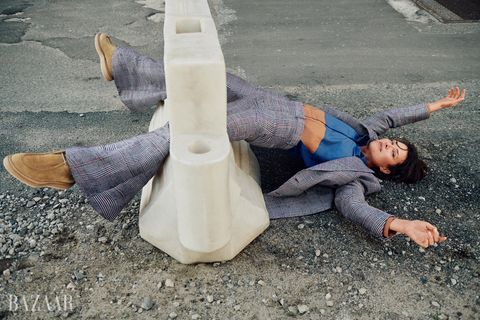 woman laying out in crosshatch gray suit with matching cross hatch bell bottom trousers