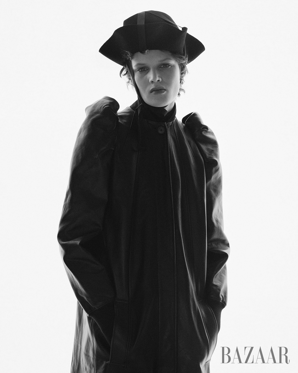 fashion portrait featuring a person in a black leather coat and a hat
