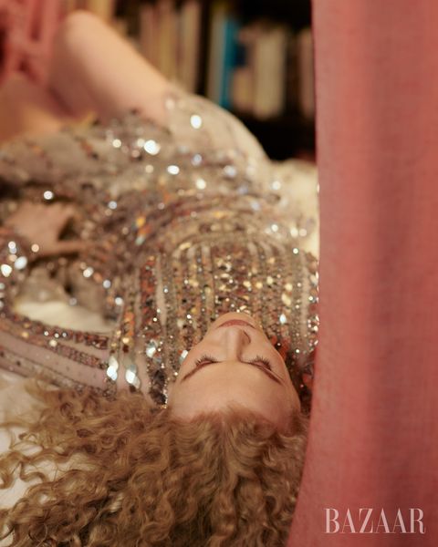 nicole lays down on floor wearing an embellished long sleeved gown