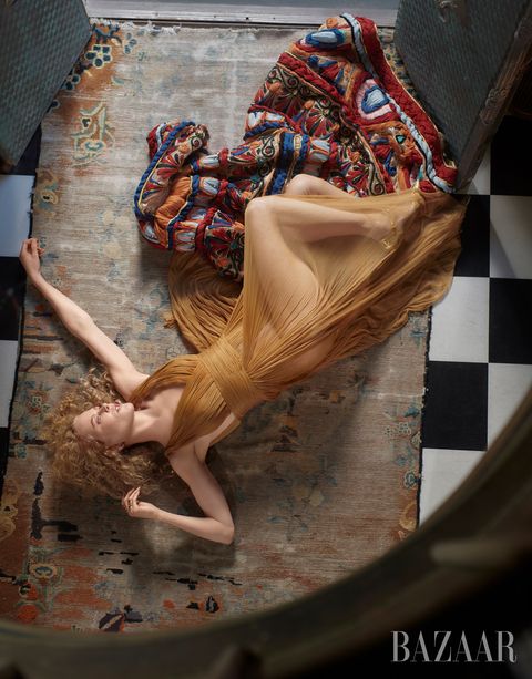 camera shot from above of nicole lying on floor wearing a sheer golden gown