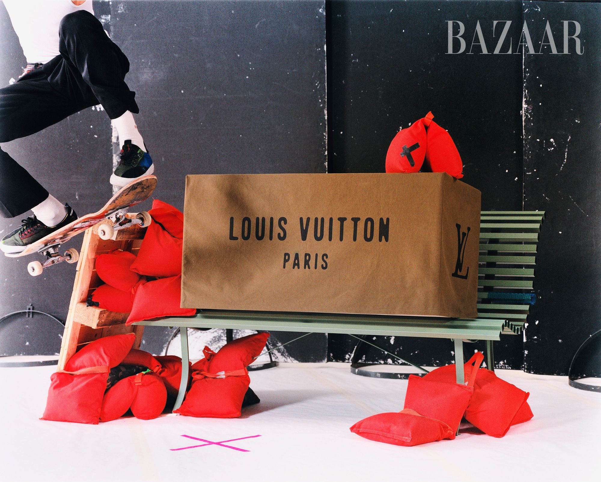 louis vuitton box on a green bench with skateboarder riding on the edge of the bench