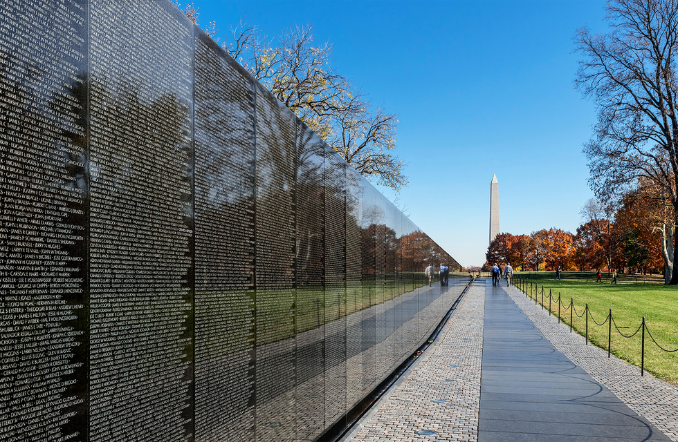 the memorial wall at the vietnam veterans memorial with the washington monument in the distance washington dc usa