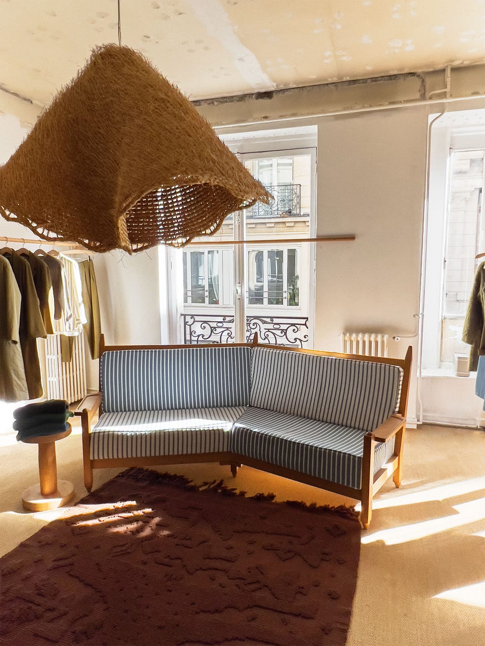 interior of a stylish room with a patterned sofa and unique light fixture