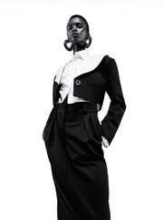model akway in black cropped suit jacket and black trousers