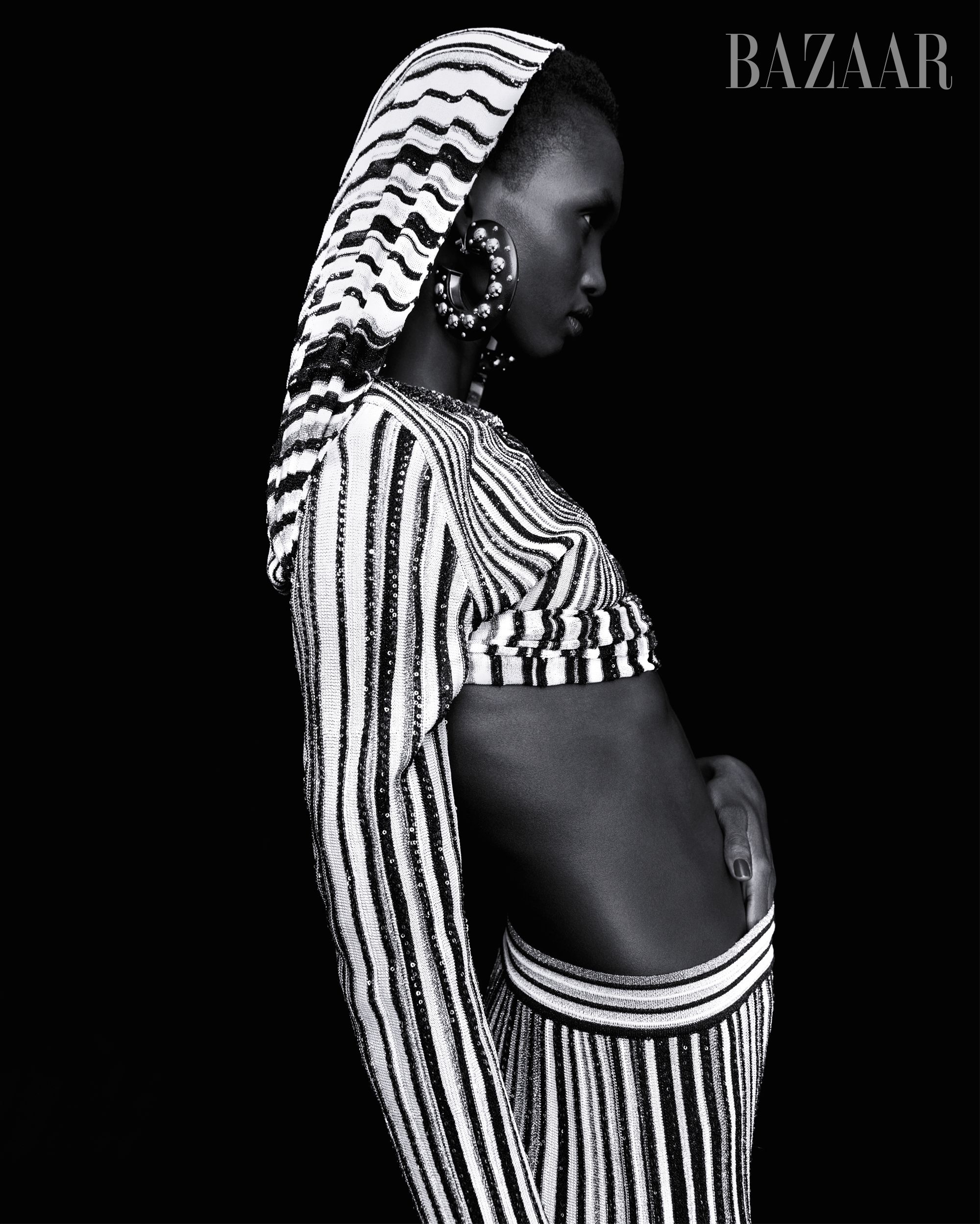 model akway in white and black striped two piece black background