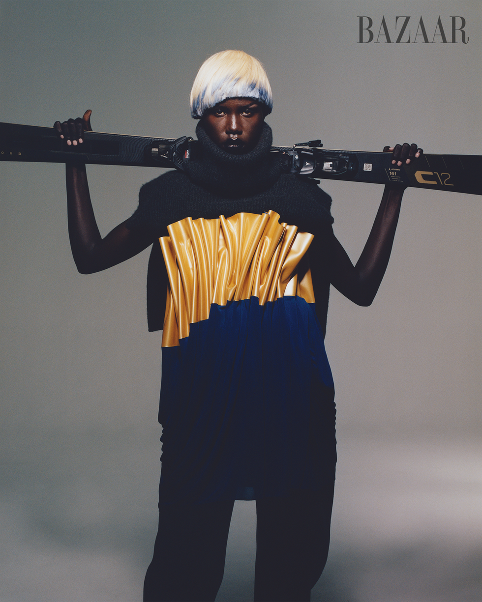 a man in a garment holding a gun