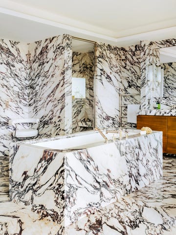 striking marble clad bathroom with freestanding bath