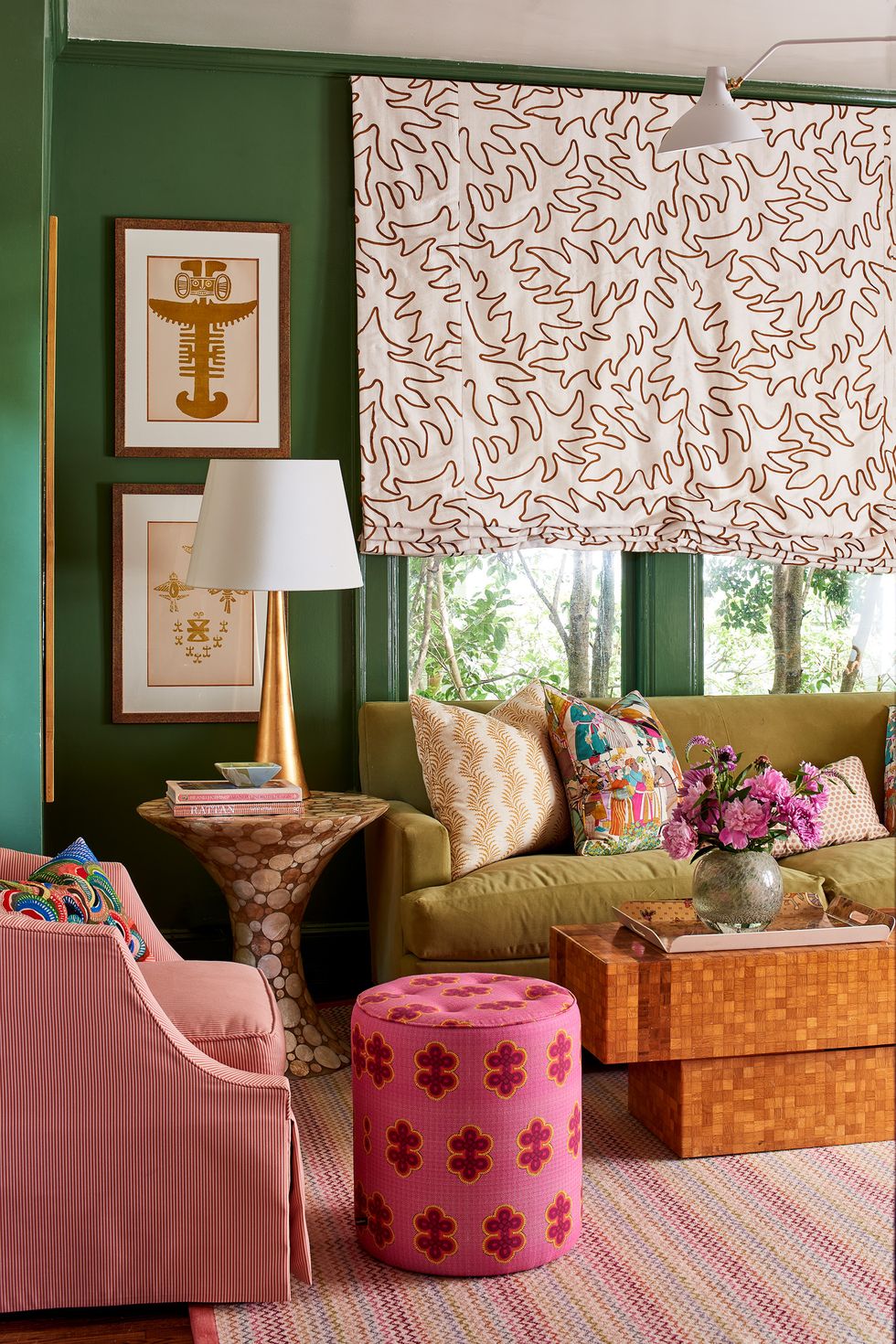 Green wall pink stool colorful living room