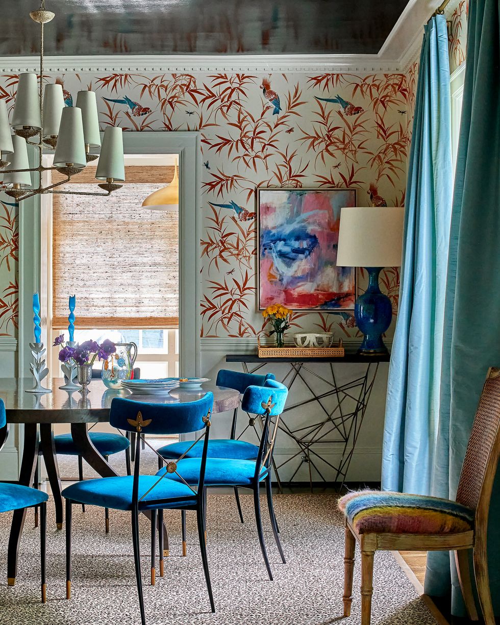 Dining room with blue chairs and blue curtains
