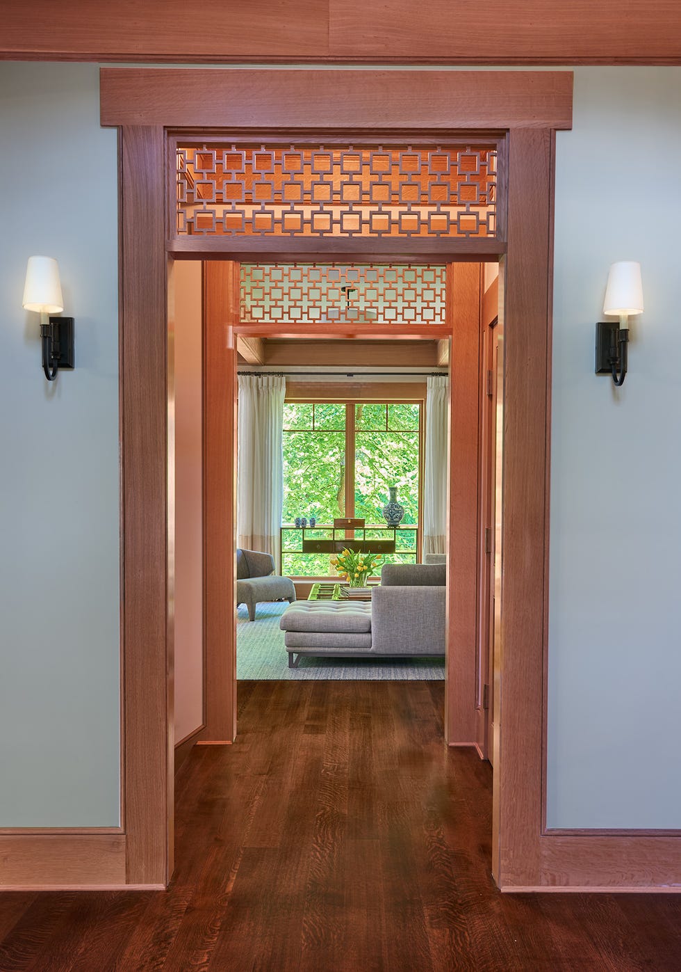 interior hallway leading to a living room with decorative features