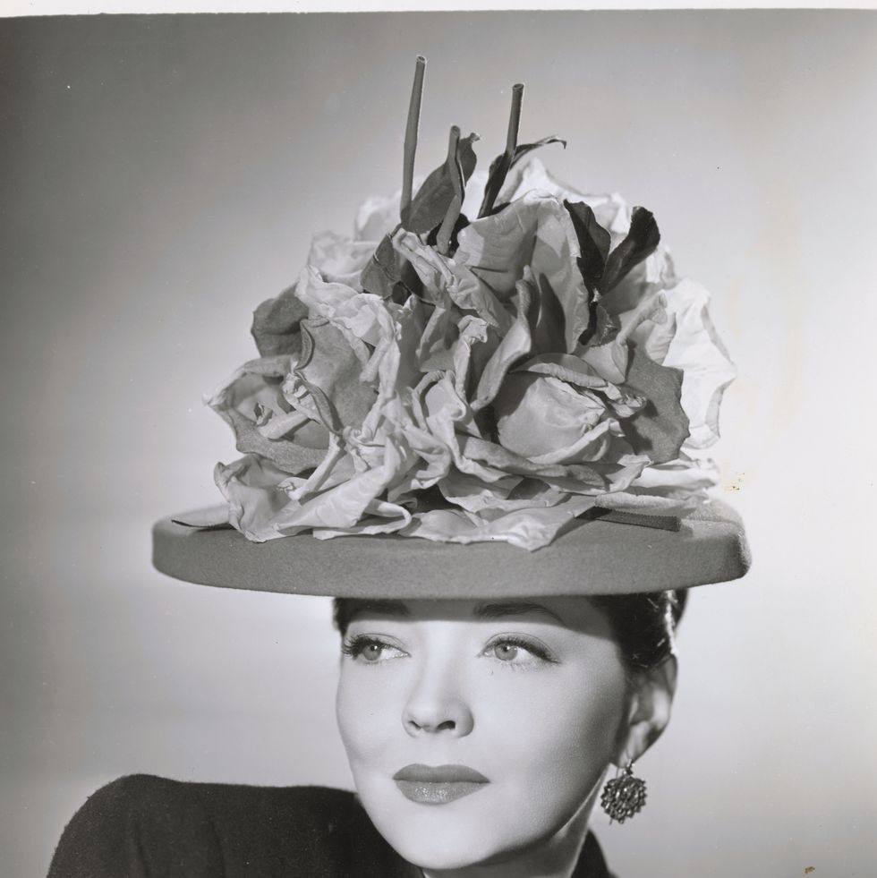 (original caption) head and shoulders publicity portrait of actress sylvia sidney wearing hat made with paper flowers.