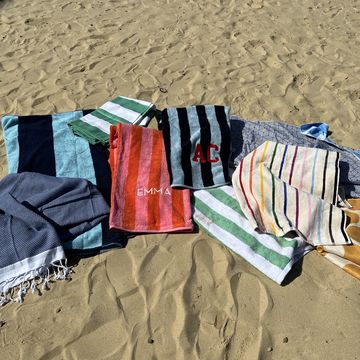 a bunch of beach towels laid out in the sand, good housekeeping's best beach towels