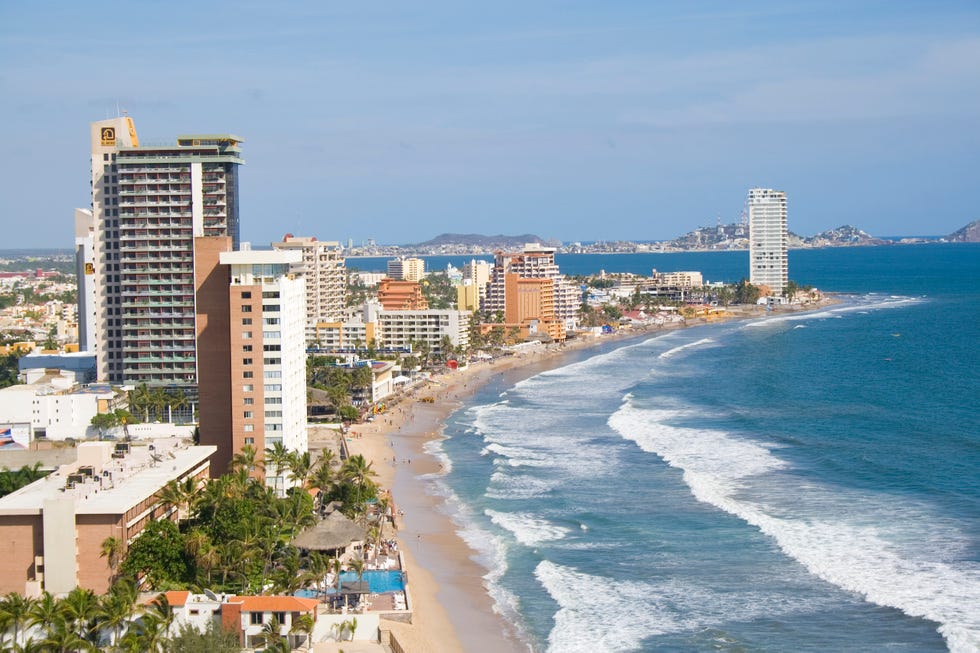 a beach with buildings along it