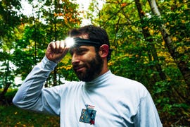 runner adjusting headlamp around forehead