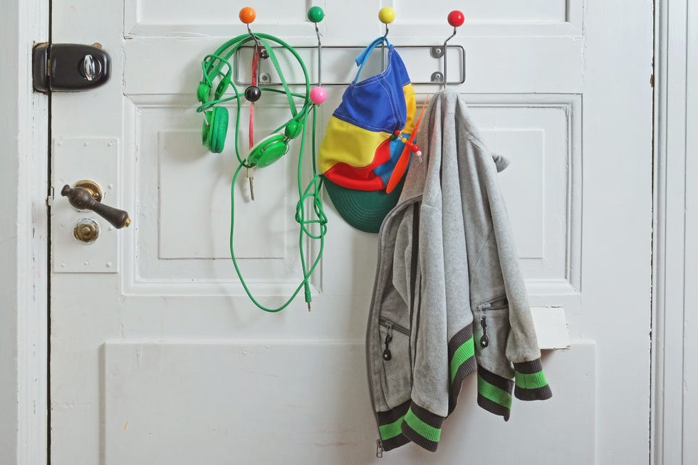 headphones, hat, and jumper, hanging on door