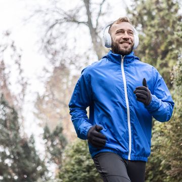 headphones on, runner in motion through the fog