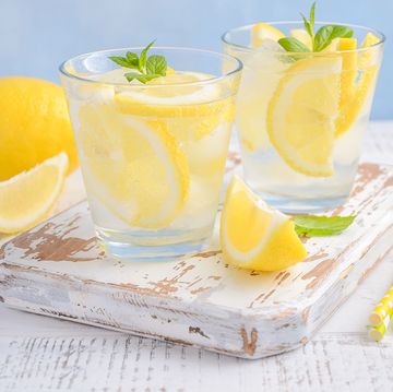 cold refreshing summer drink with lemon and mint on wooden background