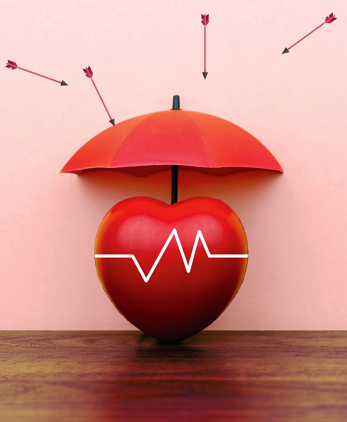 red heart under a red umbrella with arrows pointing towards it