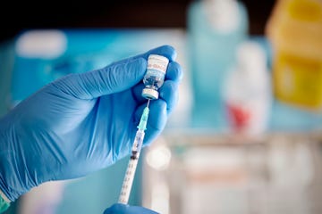 a healthcare worker prepares a dose of covid 19 vaccine