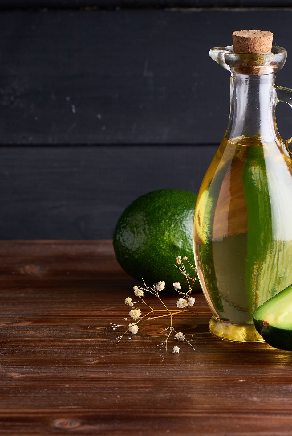 healthy avocado oil in glass bottles dark background copy space