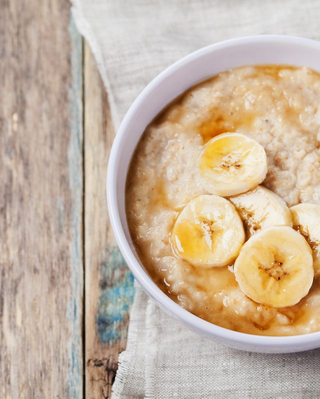 Healthy breakfast, oatmeal porridge with banana with text copy space