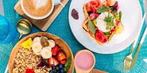 healthy breakfast with smoothie bowl and waffle with salmon and poached egg