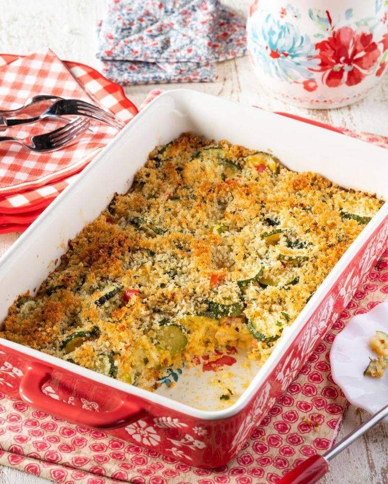 cheesy zucchini casserole in red dish