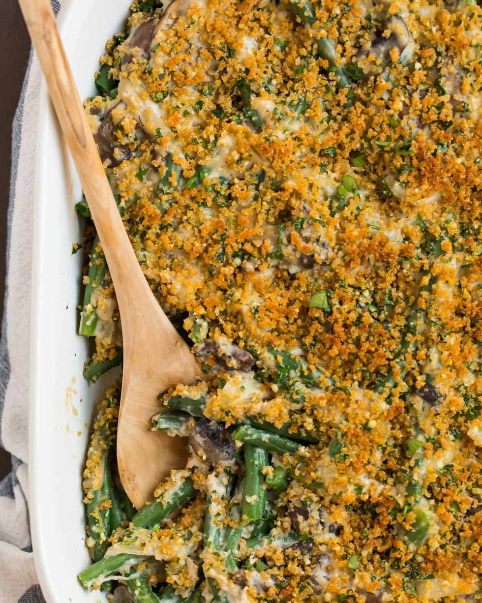 healthy green bean casserole with wooden spoon