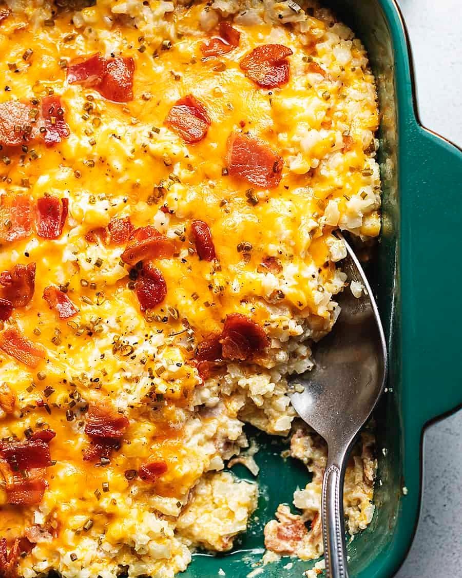 loaded cauliflower rice casserole with bacon and spoon