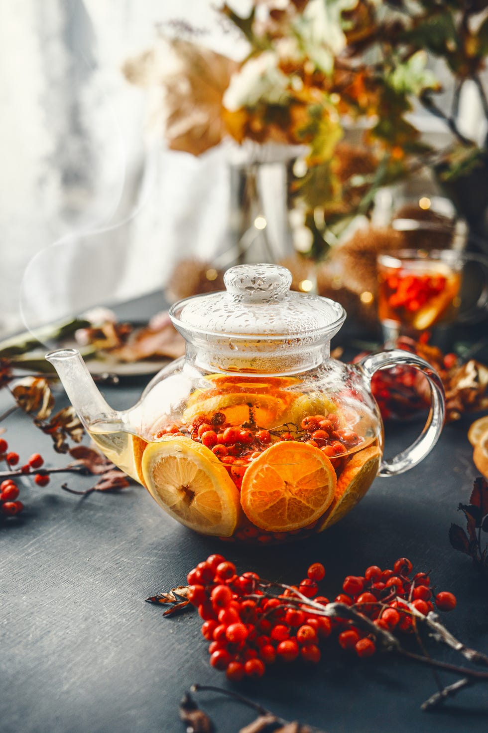 healthy citrus vitamin fruits tea in glass teapot with steam