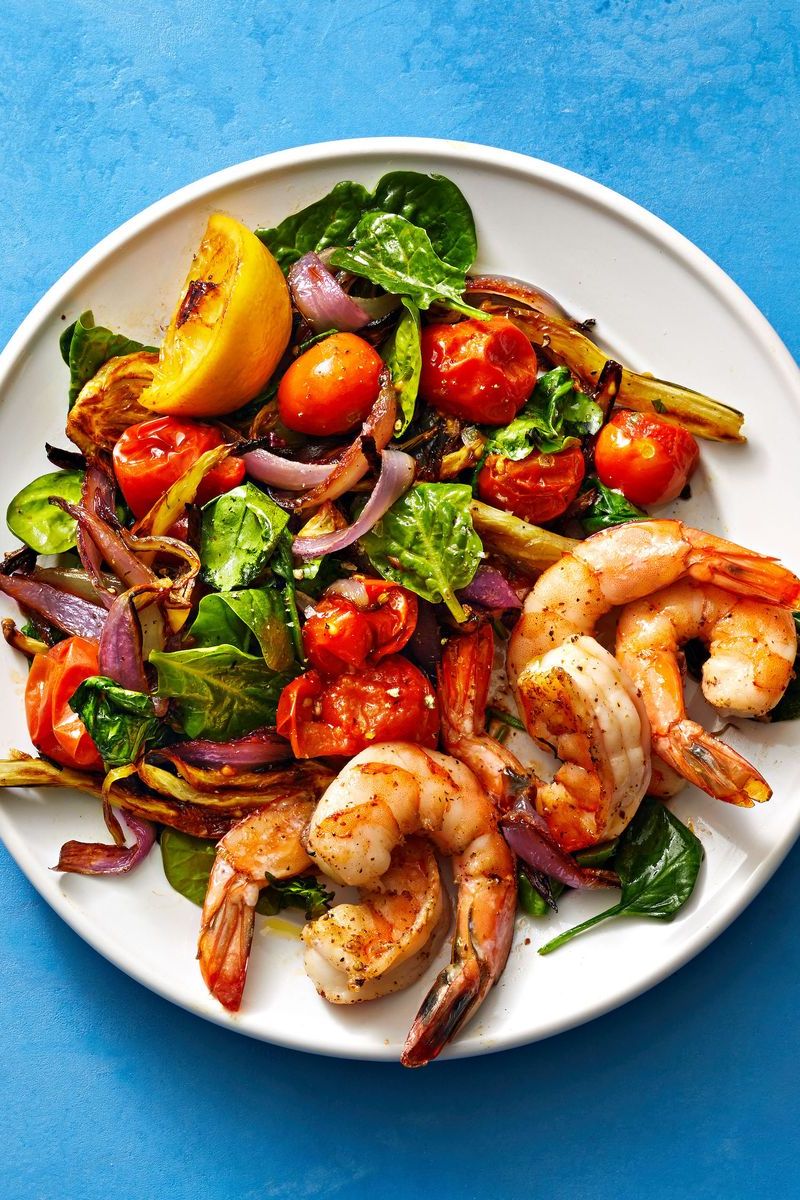 roasted shrimp with tomatoes and spinach on the side