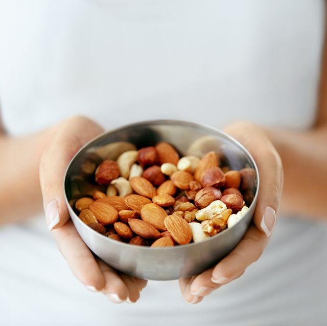 healthy food hands holding bowl with nuts