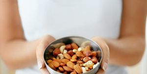 healthy food hands holding bowl with nuts
