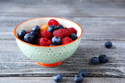 raspberries and blueberries in a bowl, food