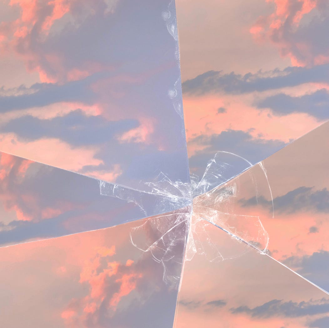 A sunset and cloudy sky with broken glass