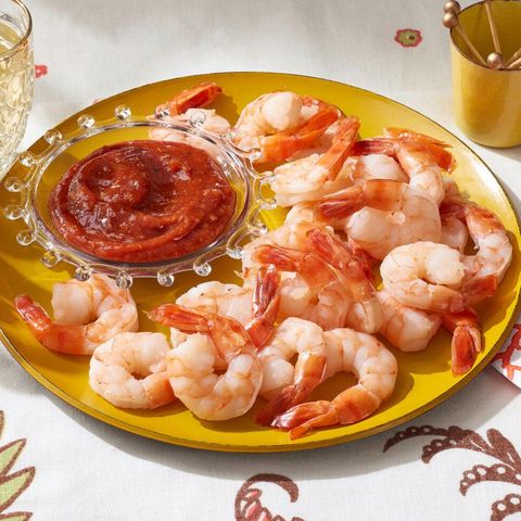 shrimp cocktail with sauce on yellow plate