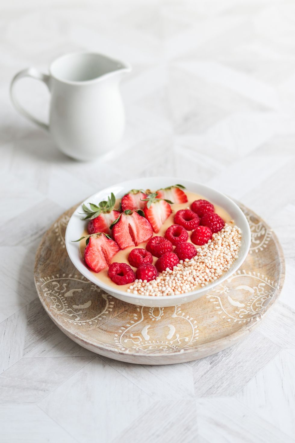 healthy vegan breakfast oats bowl with berries and puffed quinoa