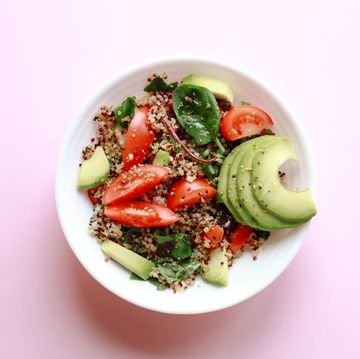 healthy vegan meal made of grain crop quinoa seed, avocado, leafy vegetables and tomato concept of healthy diet