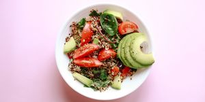 healthy vegan meal made of grain crop quinoa seed, avocado, leafy vegetables and tomato concept of healthy diet