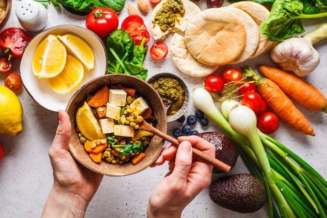 healthy vegetarian food background vegetables, pesto and lentil curry with tofu