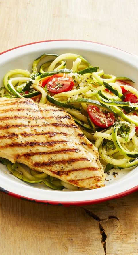 grilled chicken with zucchini noodles on white and red plate