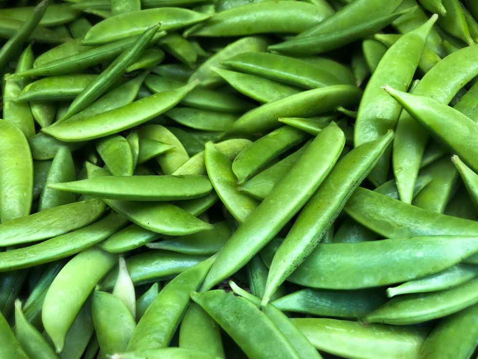 heap of fresh organic sugar snap peas at market