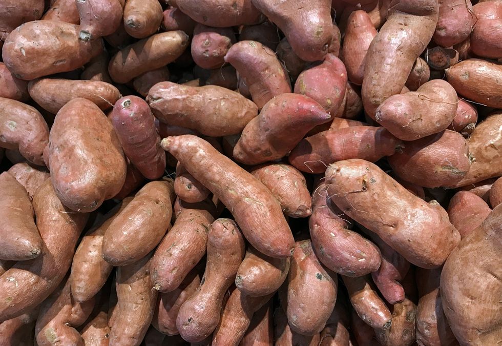 heap of sweet potato ipomoea batatas in a market