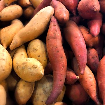 heaps of fresh organic white  sweet potatoes at market